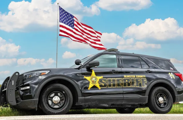Squad car with flag in the background