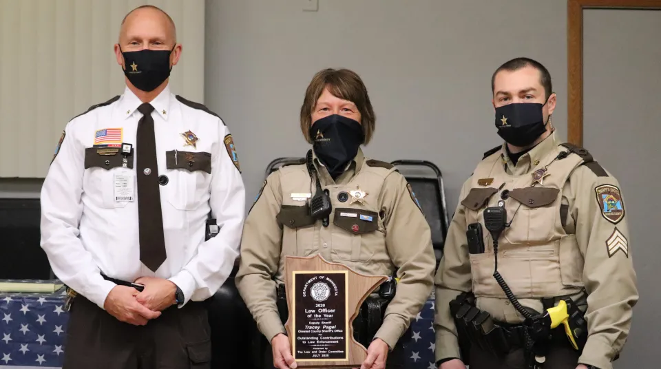 Sheriff Torgerson, Deputy Tracey Pagel with Award and Sergeant Mark Chambers