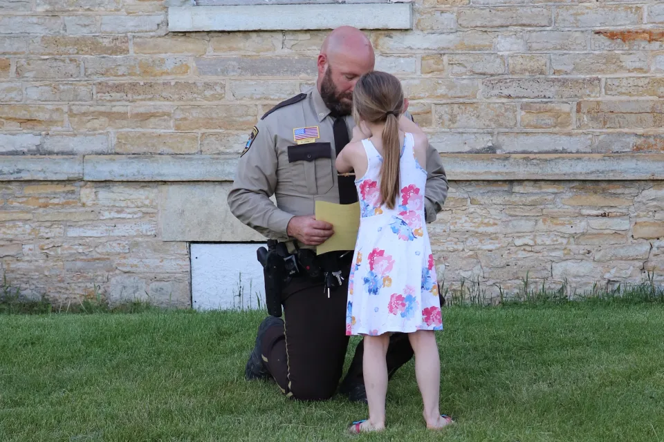 Family member pins badge on deputy.