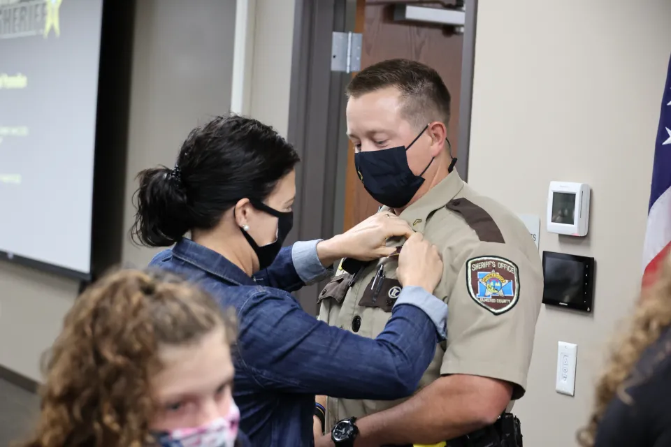 Family member pins badge on deputy