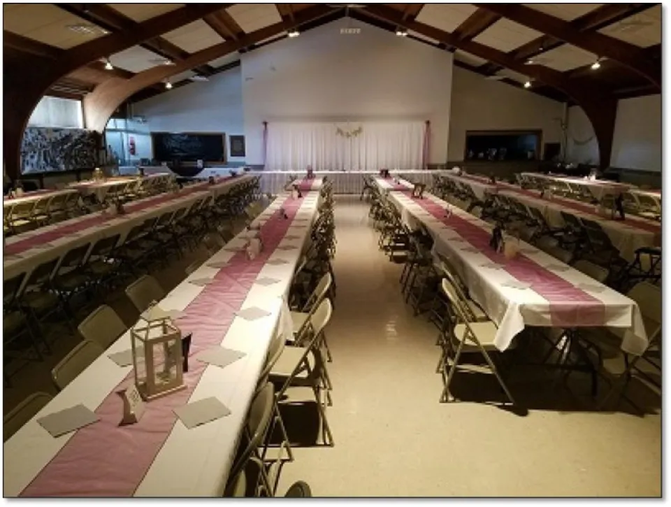 Aune Hall main room with banquet-style table settings.