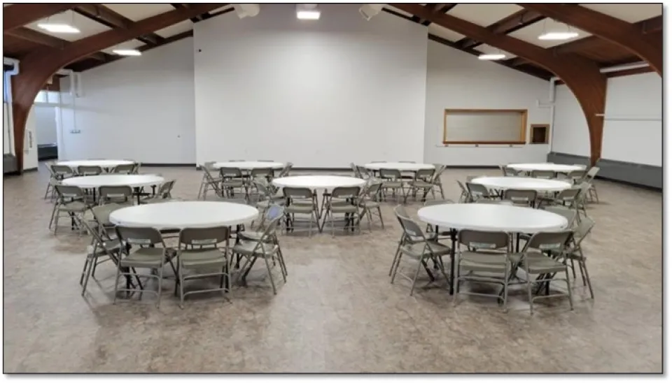 Aune Hall main room with round table settings.