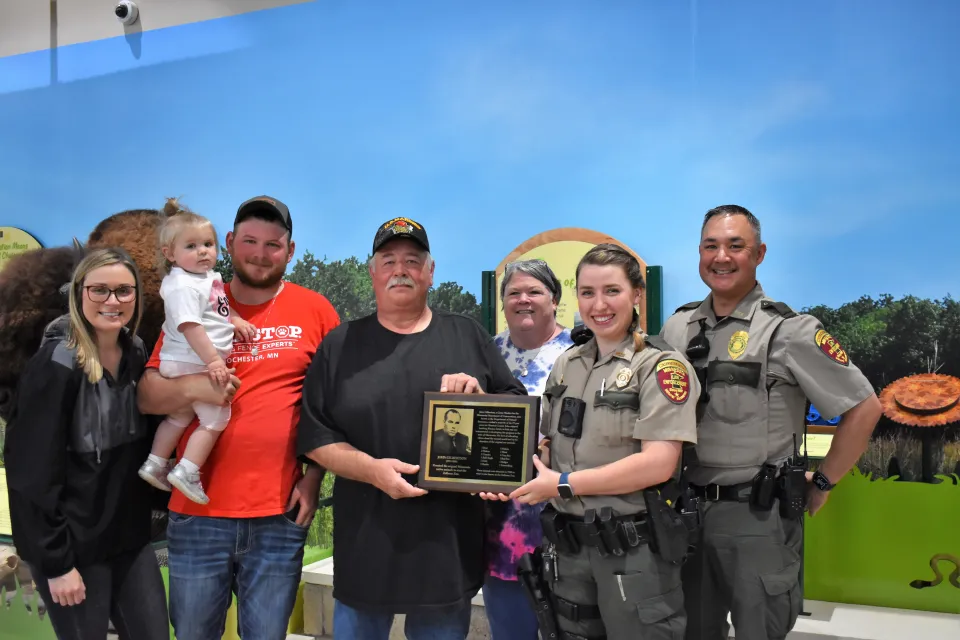 John Gilberston family and friends with plaque