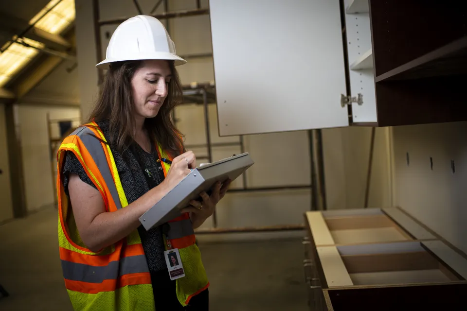 Olmsted County employee writing on clipboard