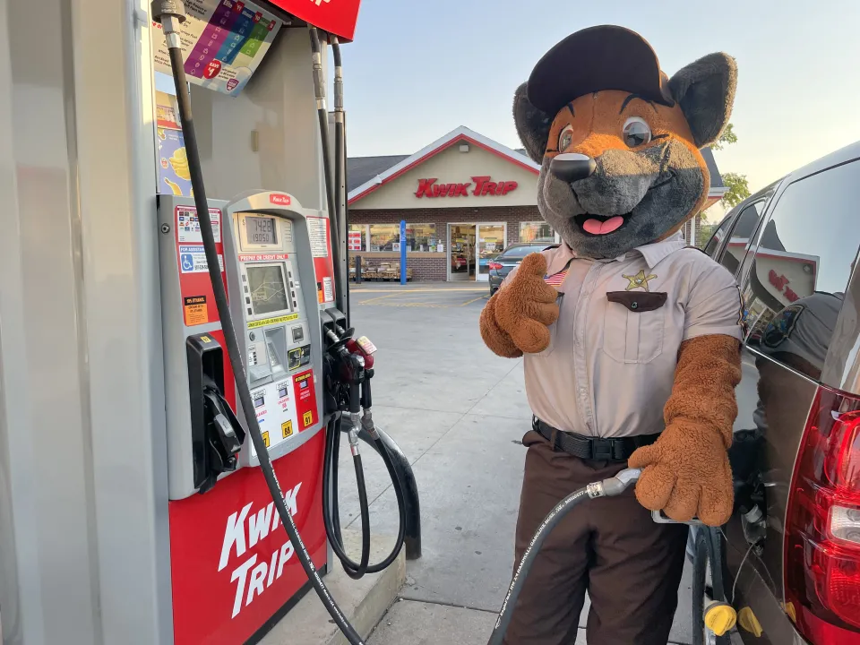 Mascot Duke standing in front of Kwik Trip