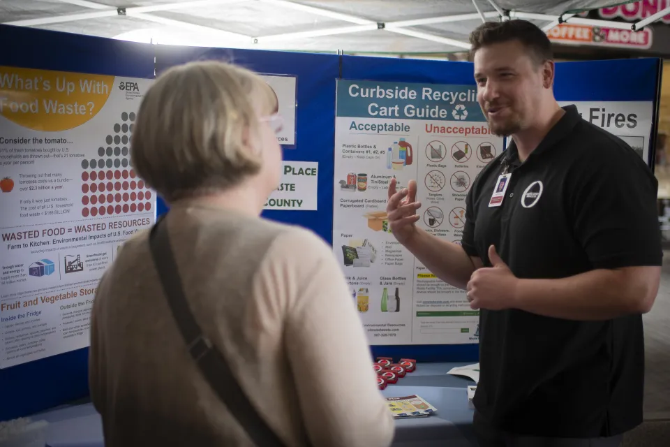 People speaking at booth