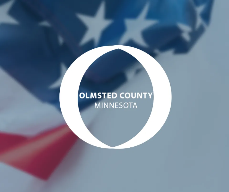 Olmsted County logo. An American flag draped in the background.