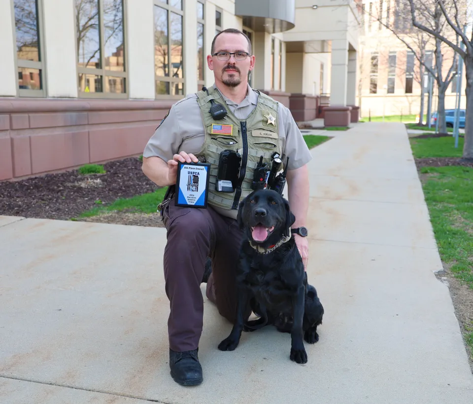 Erik Ickler and K9 Huey with Award in 2024