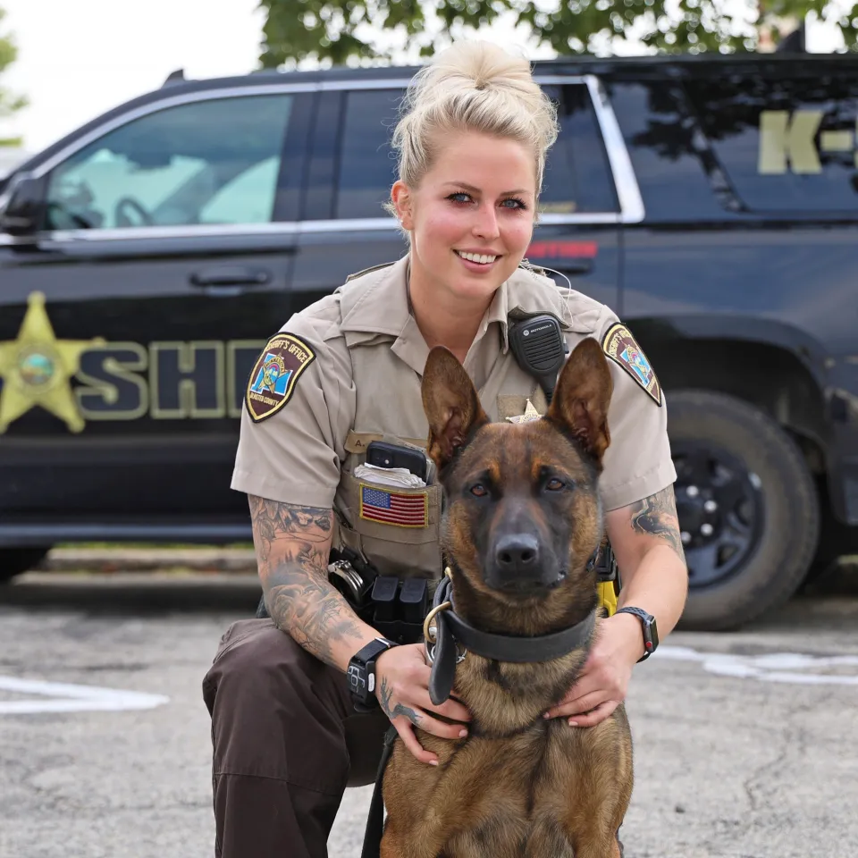 Deputy Torkelson and K9 Ragnar in front of a squad