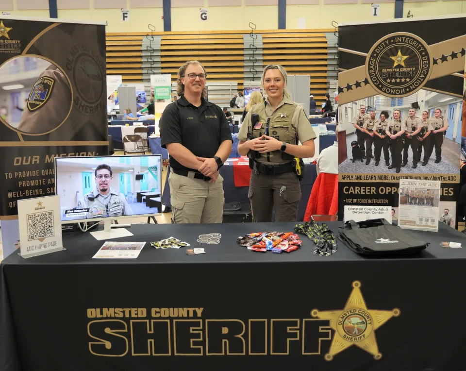 Members of the Sheriff's Office stand behind a table at a career fair