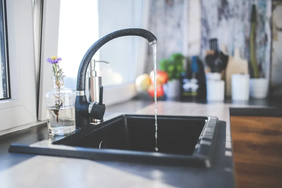 Kitchen faucet with water coming out of it