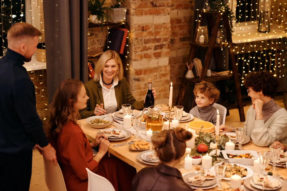 Six people celebrating the holidays over dinner