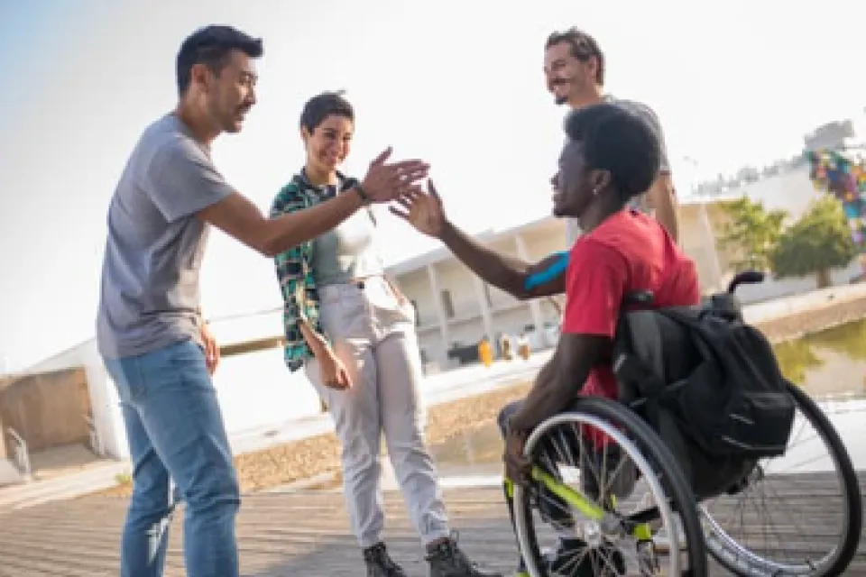 four students giving highfives