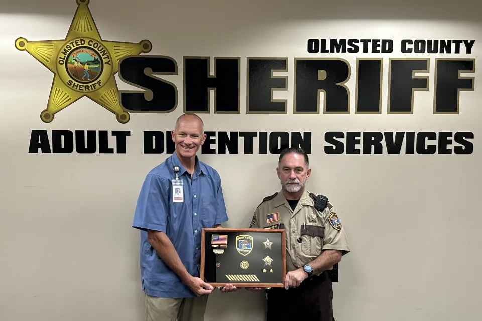 Sheriff Torgerson poses for a photo with Dave Shufelt celebrating his retirement