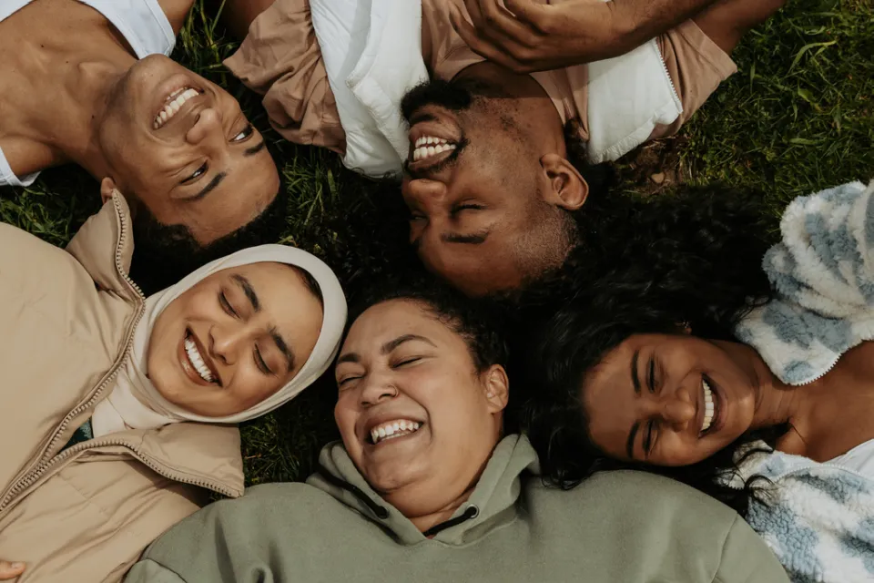 A group of people laying in a circle