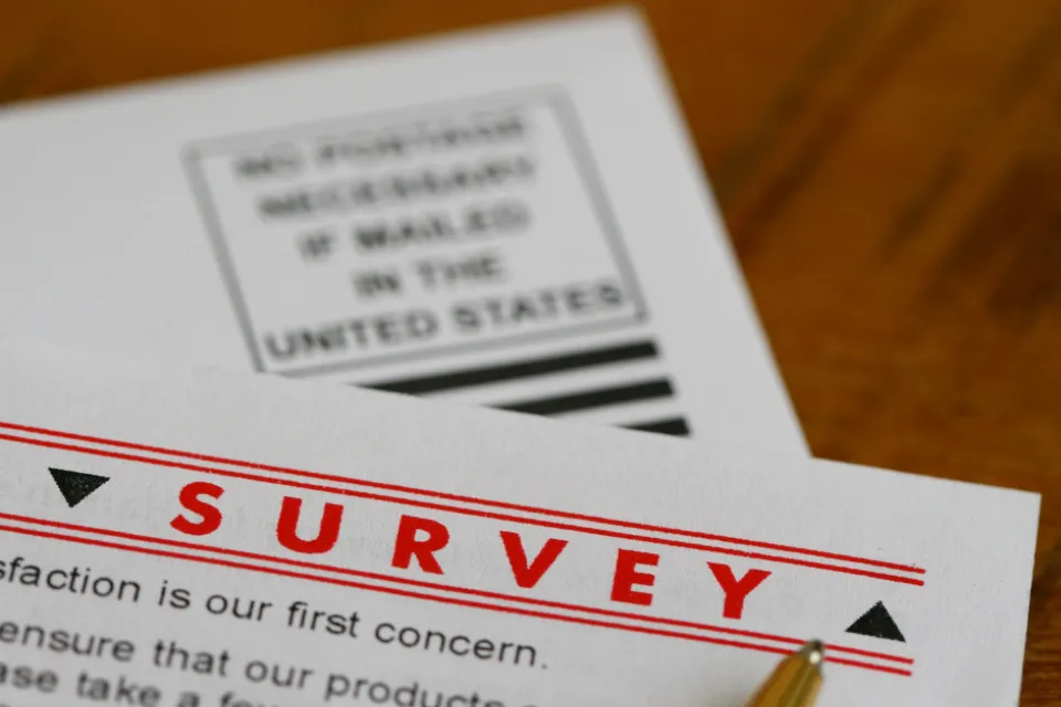 Paper survey laying on a wooden background