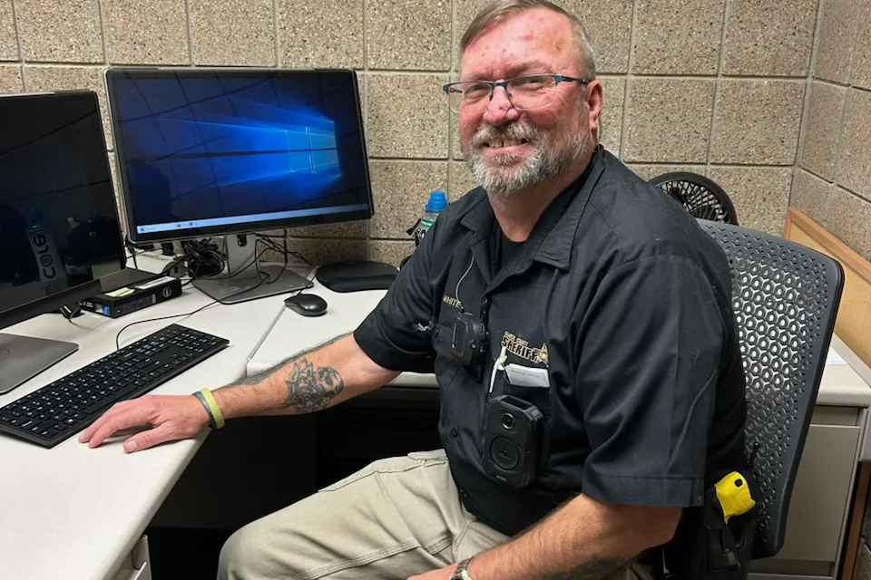 Will White sits at his desk